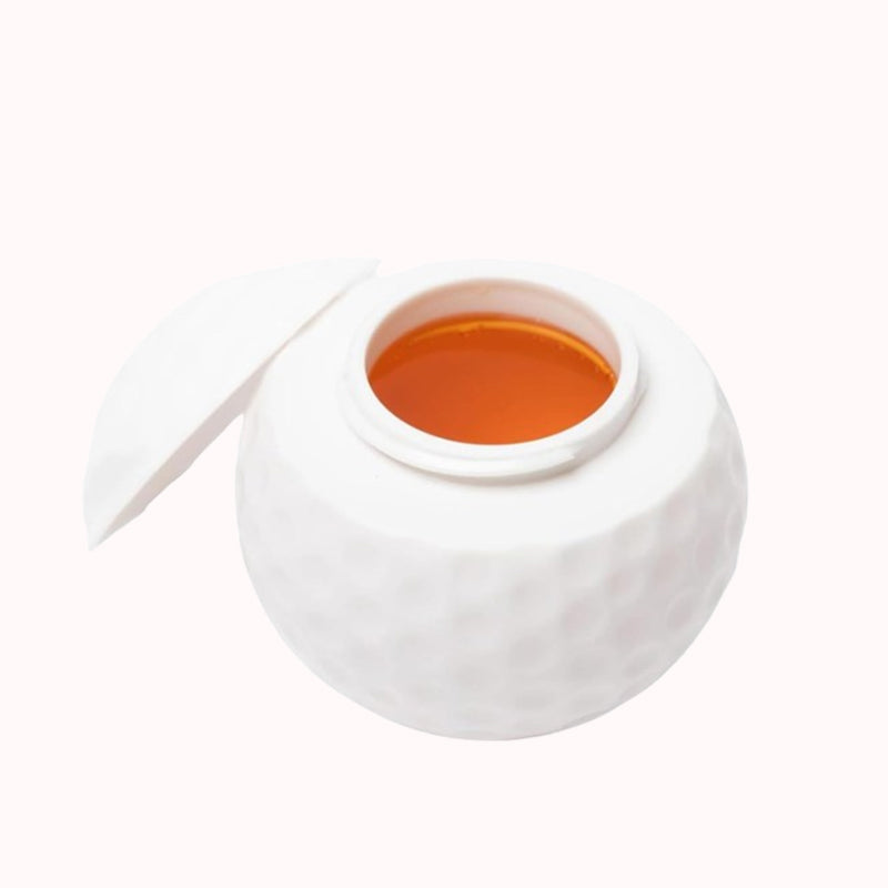 Luova golfpallon muotoinen shottilasi